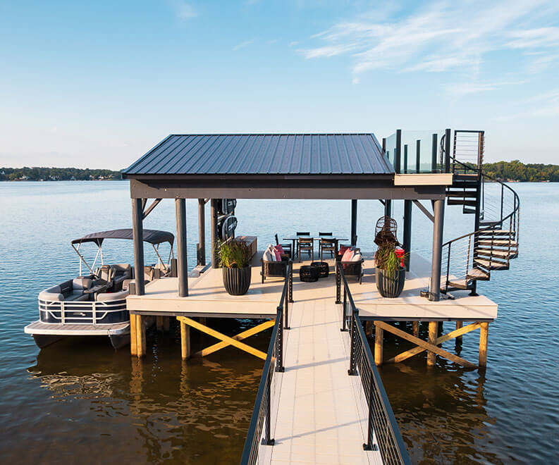 Trex Spiral Stairs Summit descending from an elevated lakeside boathouse deck