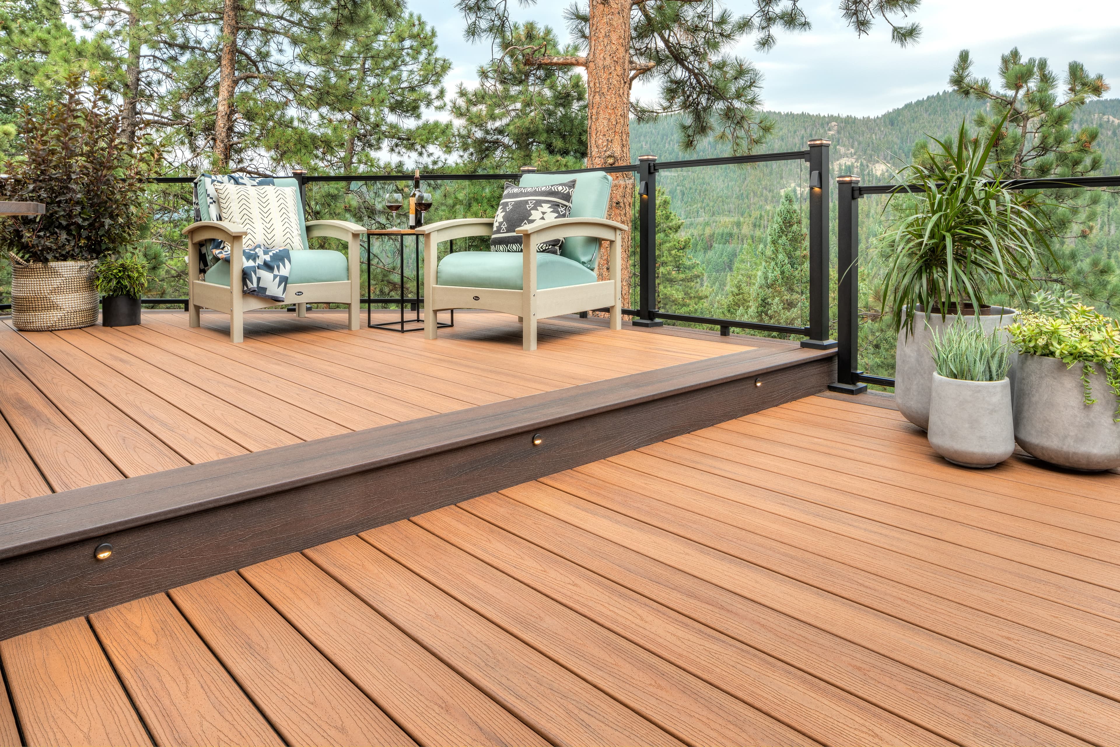 Trex Signature glass railing with corner step and planters